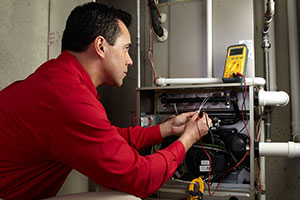 Technician inspecting a residential heating system