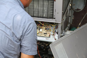 Technician repairing a HVAC system